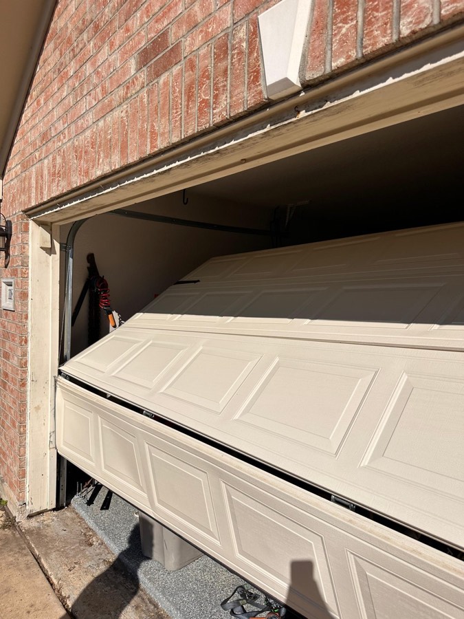 Dented garage door panel before replacement