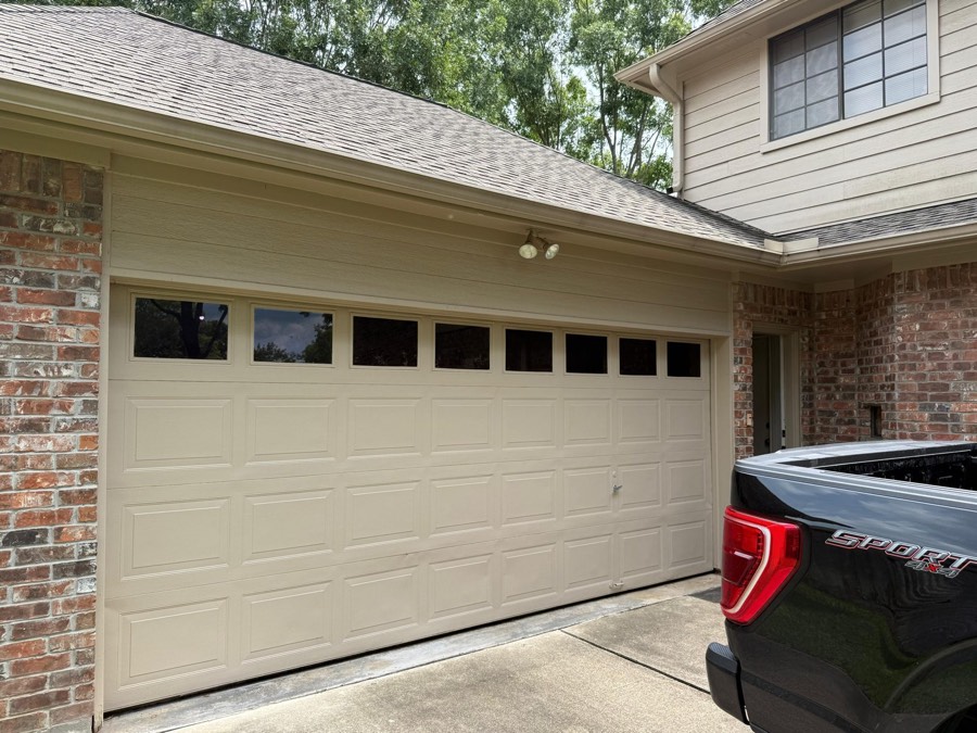 New insulated garage door installed on a brick home