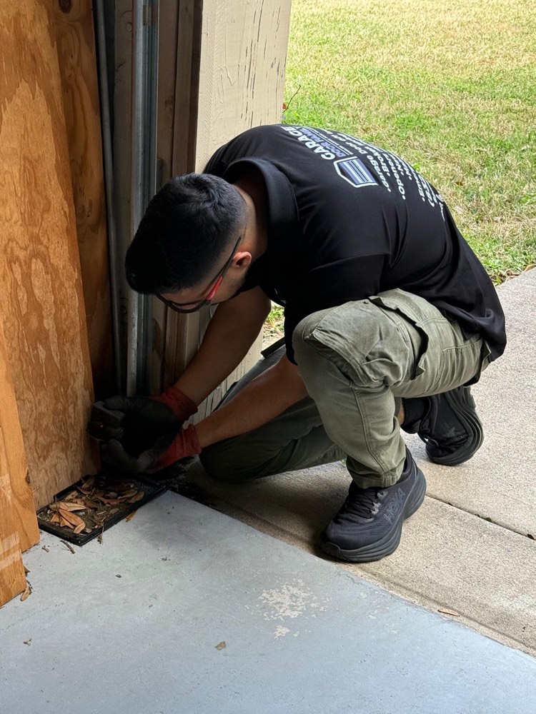 Garage door technician working at a residential garage door